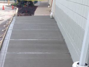 Concrete After Apartment Concrete Sidewalk Finished With Forms Near Wall And Playground In Back